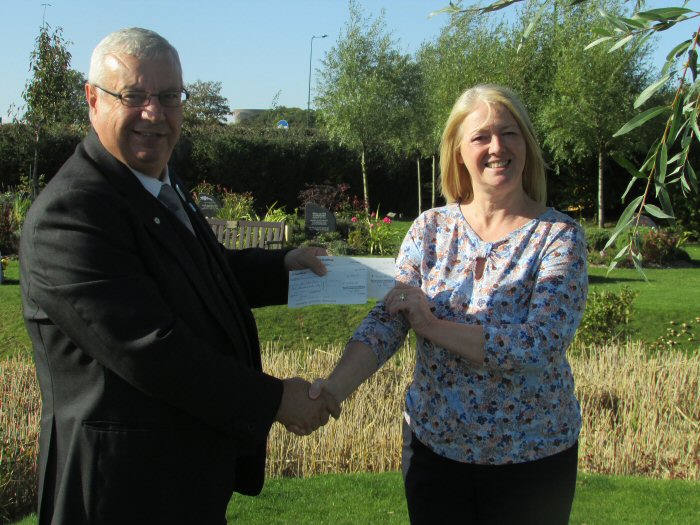 Chapel Attendant Ray Lawton, presenting the cheque to to Victoria Rogers from Zoe’s Place